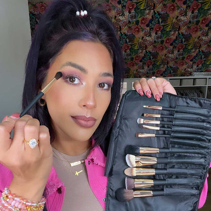 Aria Pro 12-Piece Makeup Brush Set in black travel clutch held by woman applying professional eyeshadow.