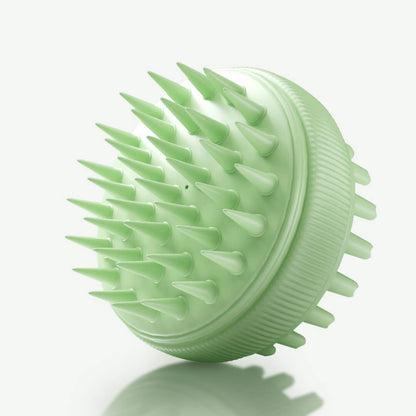 Mint green Charlotte silicone scalp massager brush with exfoliating bristles for hair growth and scalp detox.