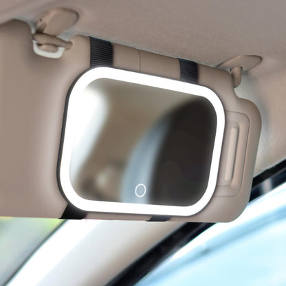 Juni 2 lighted car visor mirror with bright LED vanity lights strapped to a vehicle sun visor for travel makeup.