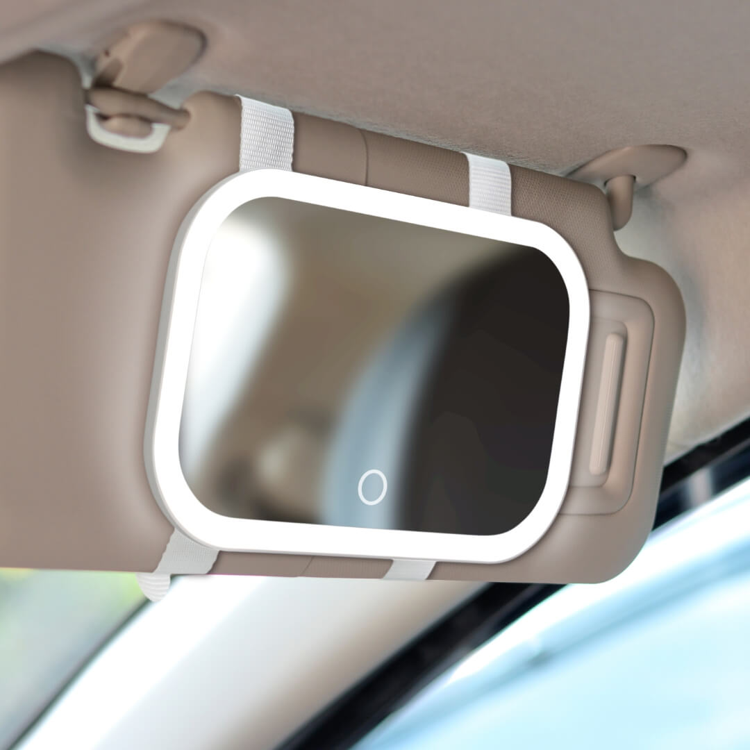 Juni 2 lighted car visor makeup mirror with LED ring light and touch sensor attached to a tan vehicle sun visor.