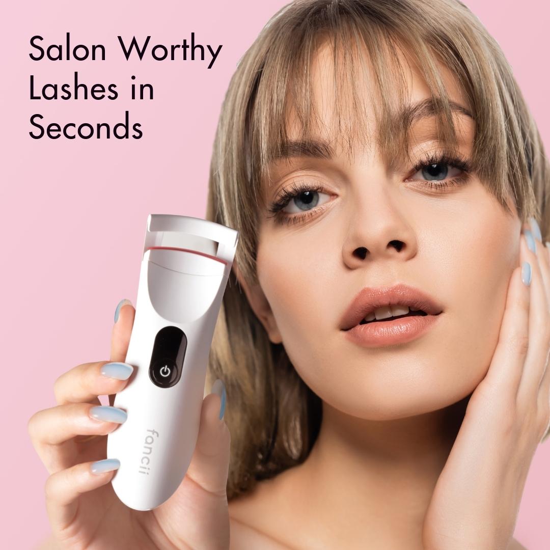 Model holding the Tasha Heated Eyelash Curler by Fancii, showcasing lifted lashes and ergonomic electric design.