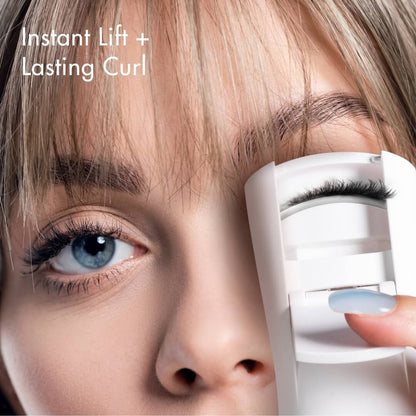 Model using Tasha Heated Eyelash Curler for instant lift and lasting curl. Handheld electric lash tool with silicone pad.