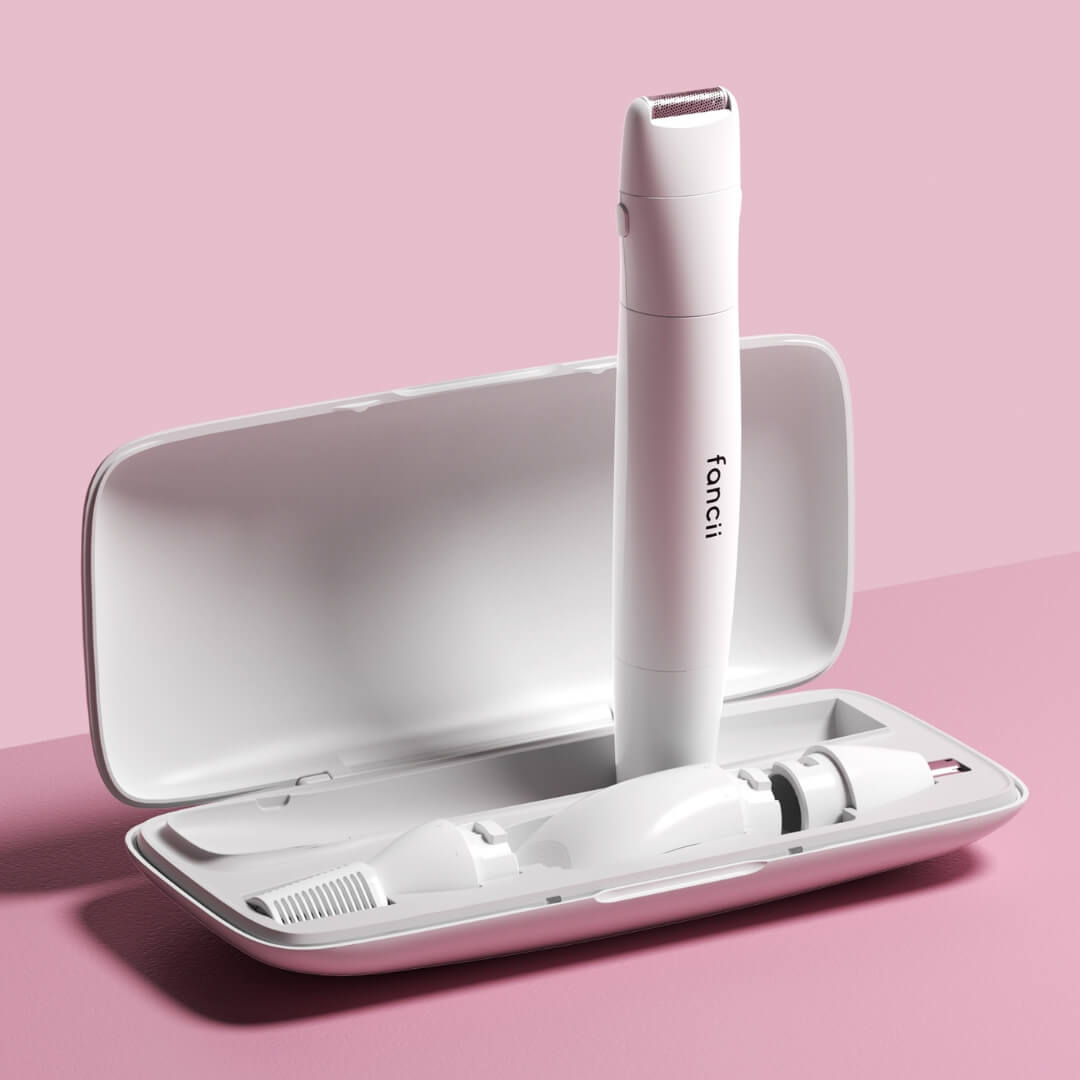 Torri face and body trimmer set with interchangeable precision heads and storage case on a pink background.
