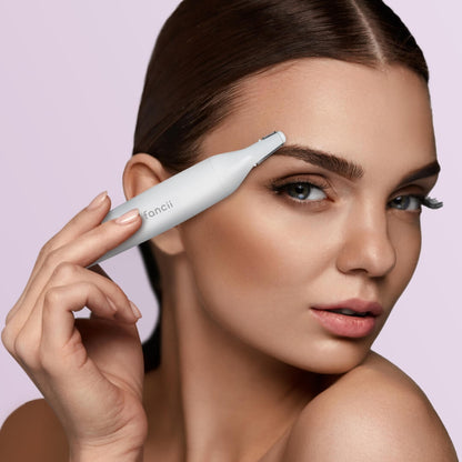 Woman using the Torri white electric precision facial hair remover and eyebrow trimmer for painless grooming.