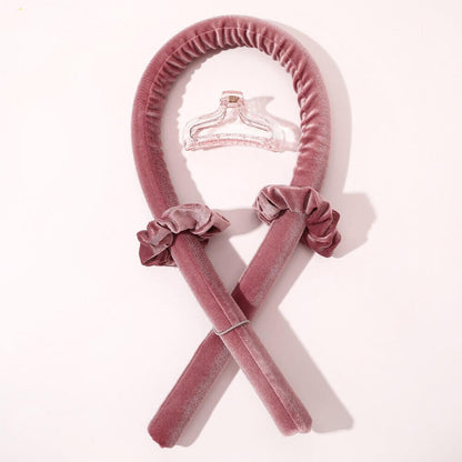 Pink velvet heatless hair curler set with two matching scrunchies and a clear claw clip for overnight heatless curls.