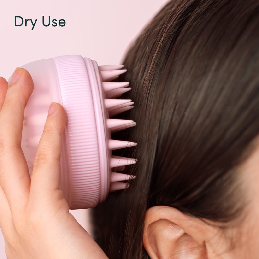 Pink Charlotte silicone scalp massager being used on dry hair for exfoliating massage and hair growth stimulation.
