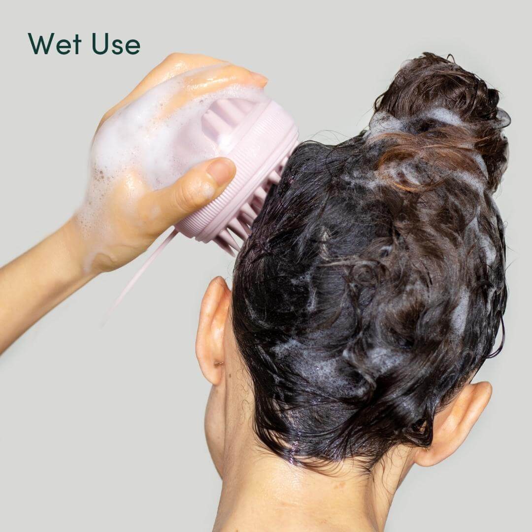 Using the Charlotte silicone scalp massager on wet, soapy hair for exfoliating and stimulating hair growth.