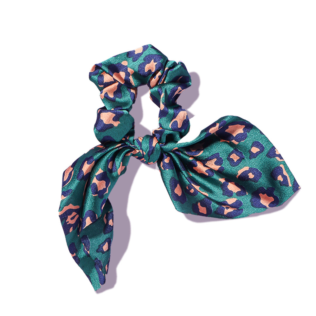 Elle satin hair scrunchie with a stylish bow, featuring a green and pink leopard print fabric on a white background.